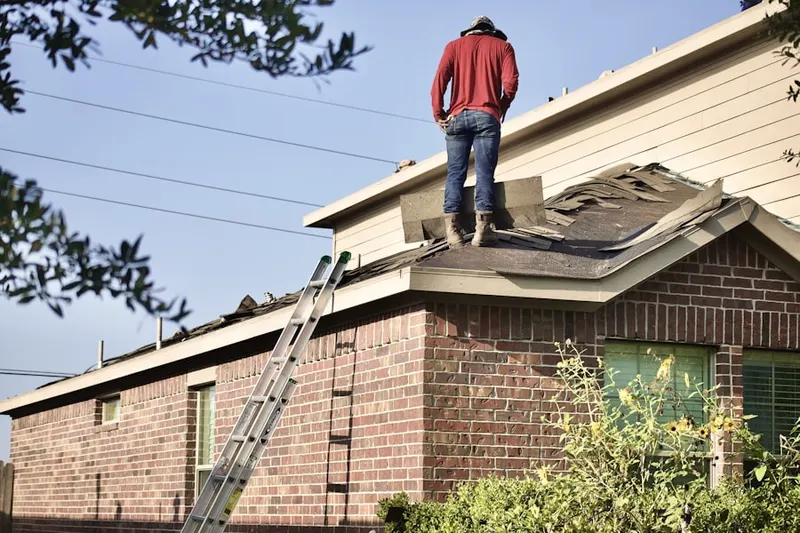Professional roofer working on a residential roof in Apache Oaks